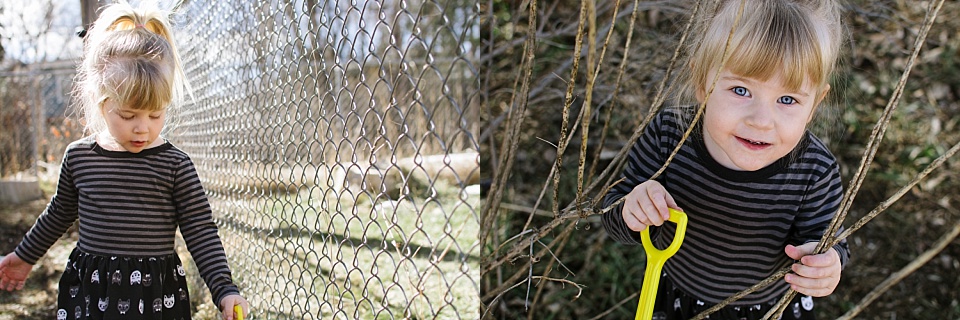 girl smiling while playing near fence