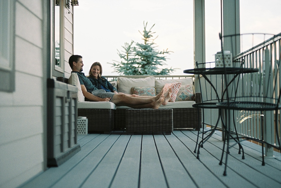 couple sitting on back porch on a summer evening