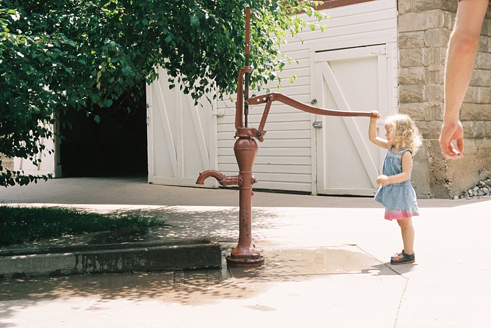 girl playing with water pump