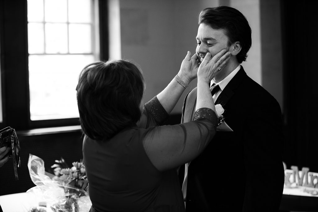mother of groom touching his face