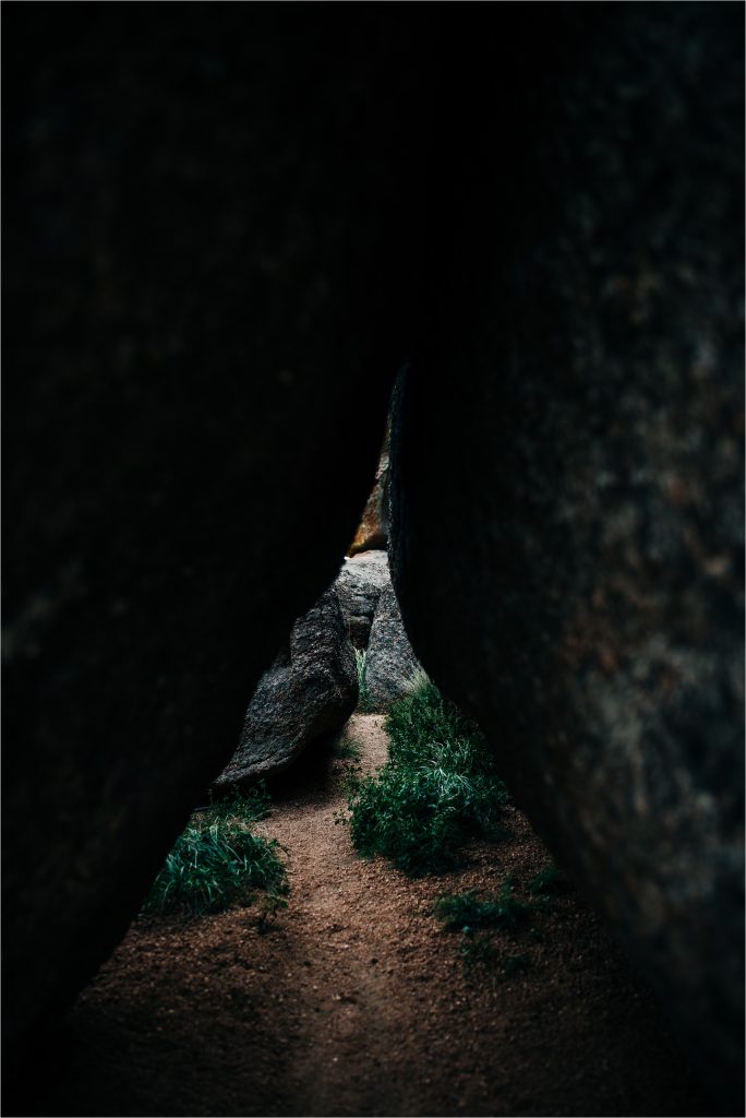 Looking through boulders, to path beyond.