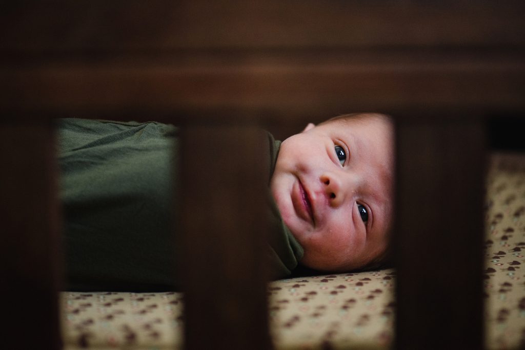 Baby smiling in crib