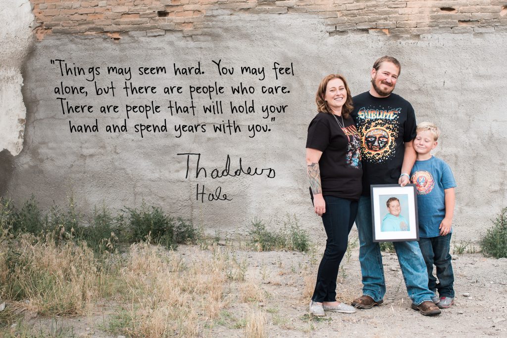 family holding photo of son with quote