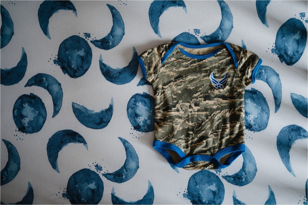 Air Force onesie on moon crib sheets.