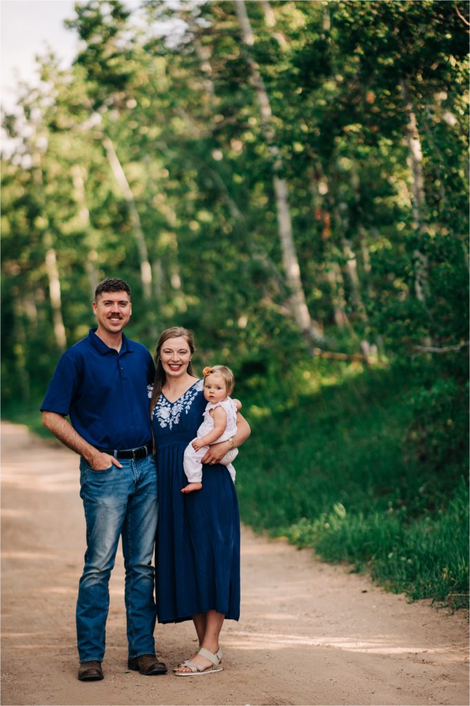 Family standing on dirt road during Wyoming mountain session.