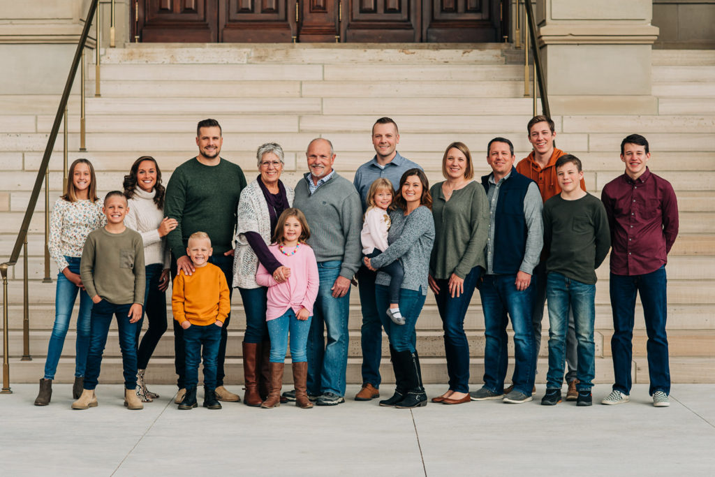 Large family standing near steps of Wyoming State Capitol building in Cheyenne, Wyoming.
